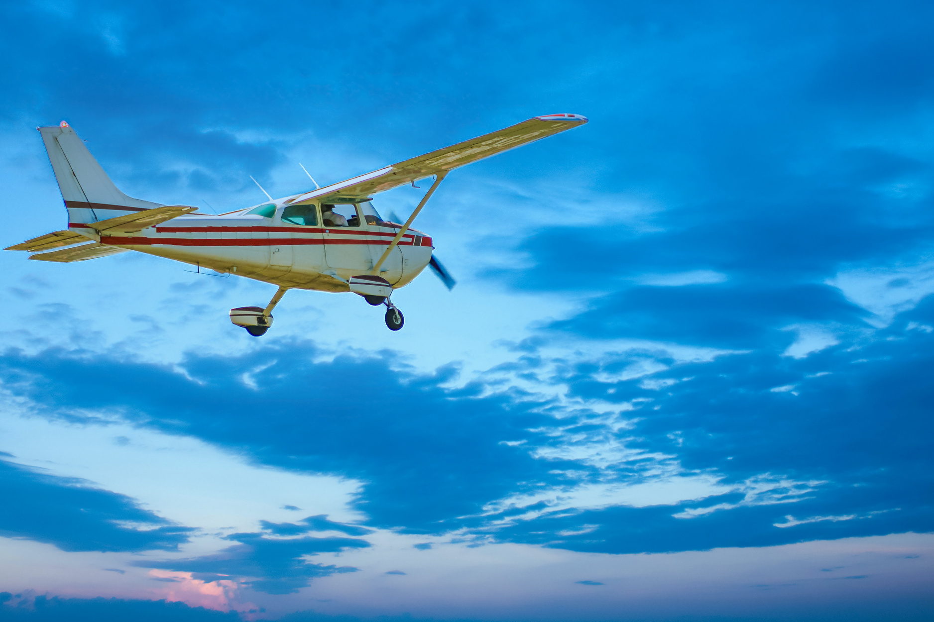 Small Plane Flying Into Dusk